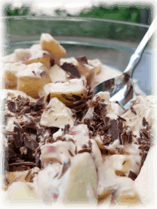"not snickers salad" in bowl with spoon - yogurt, apples, chocolate