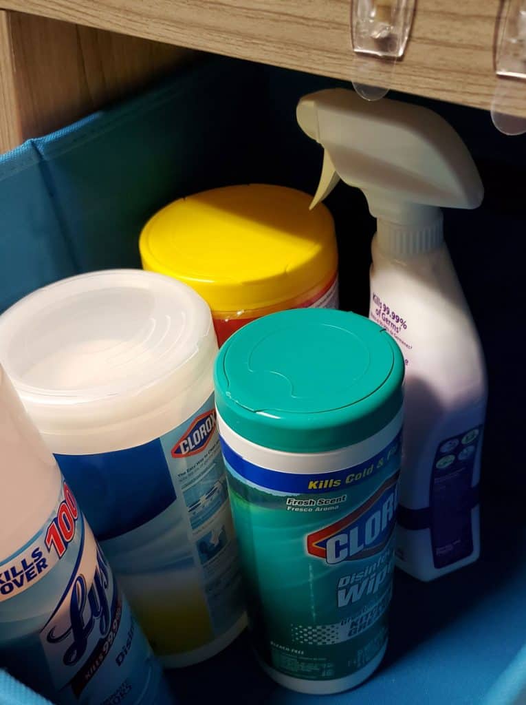 inside of face mask organizing bin with disinfectants, clorox wipes sanitizing spray
